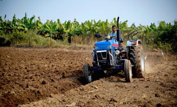 Indian farmer working with tractor in agriculture field. Indian farmer working with tractor in agriculture field.